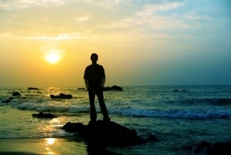 man on beach at sunset
