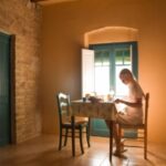 female at table writing