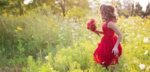 young woman in field of flowers