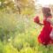 young woman in field of flowers