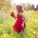 young woman in field of flowers