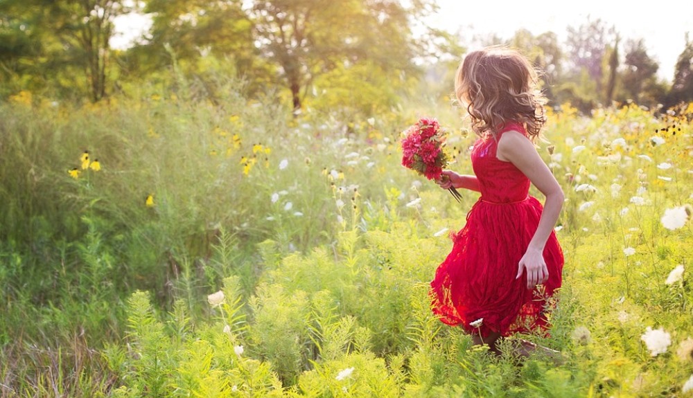 young woman in field of flowers